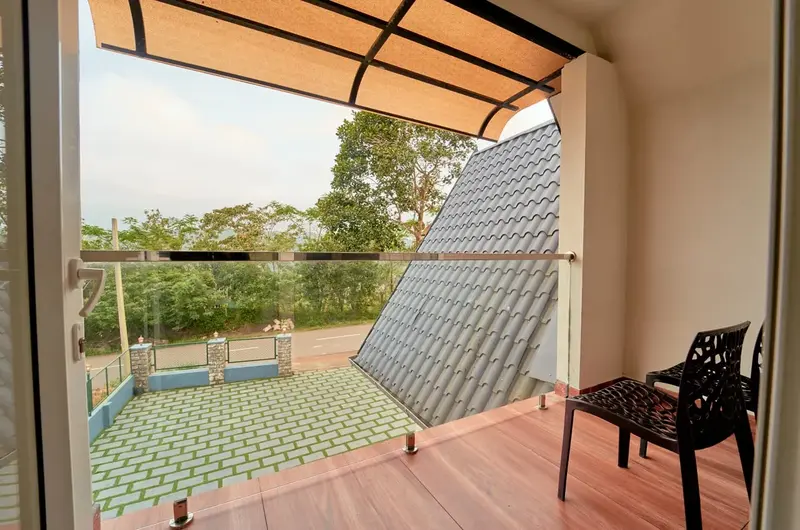 Villa balcony sit-out area with safety netting at Choice Holidays Resort Vagamon.