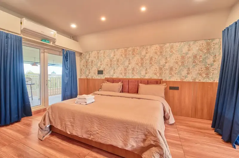 Premium king bed suite with scenic view door at Voye Homes Vagamon villa.