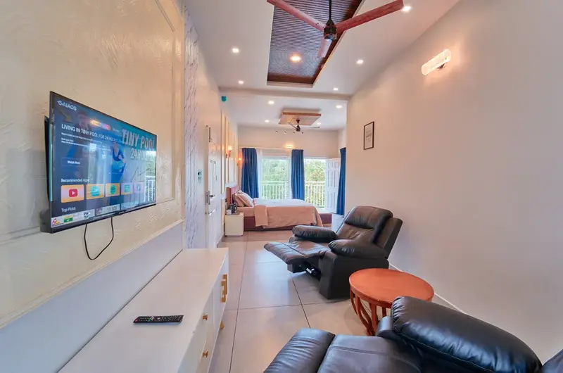 Spacious family suite room interior with multiple beds and seating area at Choice Holidays Resort Vagamon.