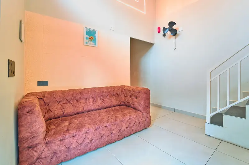 Cozy villa living room interior with a comfortable plush sofa at Choice Holidays Resort Vagamon.