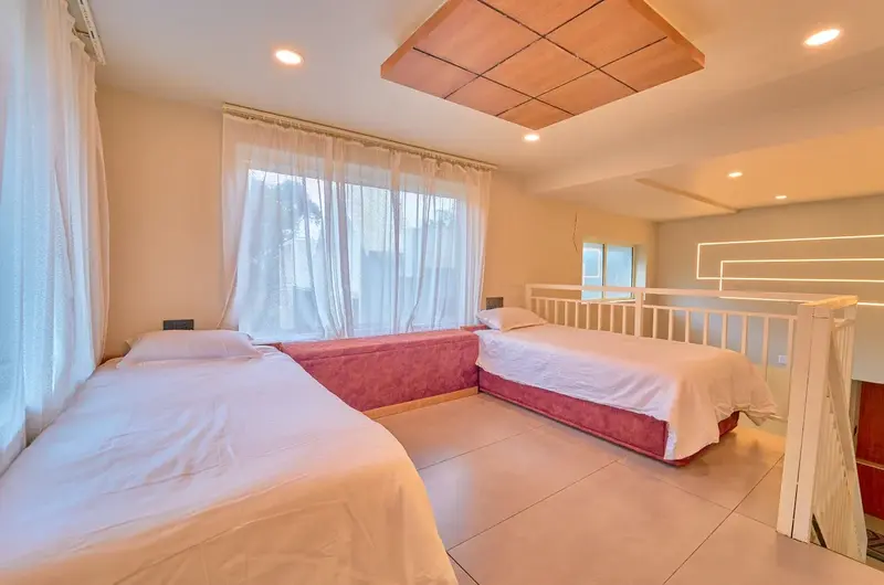 Duplex family room setup with multiple beds at Choice Holidays Resort Vagamon.