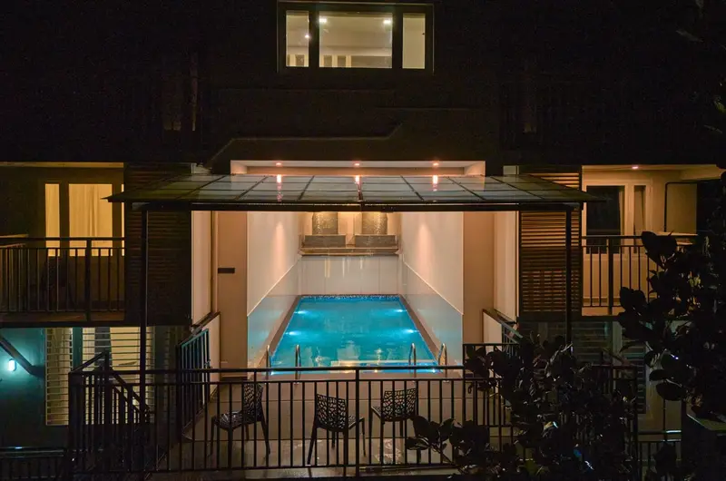 Luxury villa amenities featuring an illuminated indoor pool at Voye Homes Vagamon.