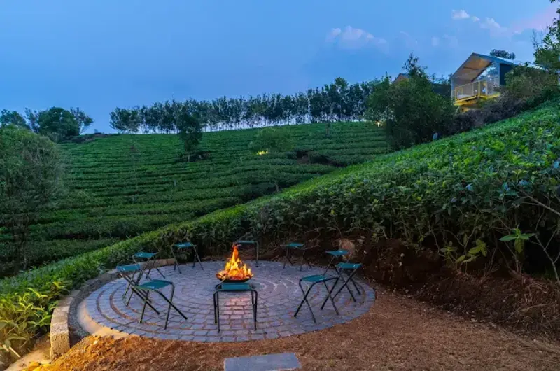 Cozy bonfire spot with panoramic nature views at a luxury Vagamon villa.