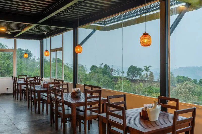 Scenic in-house cafe and dining space with mountain views at a Vagamon resort.