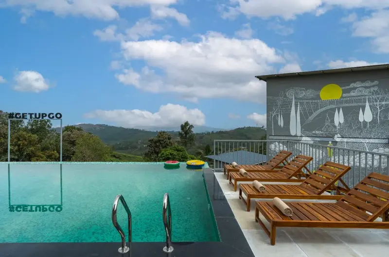 Luxury pool area with scenic mountain views at a premium resort in Vagamon.