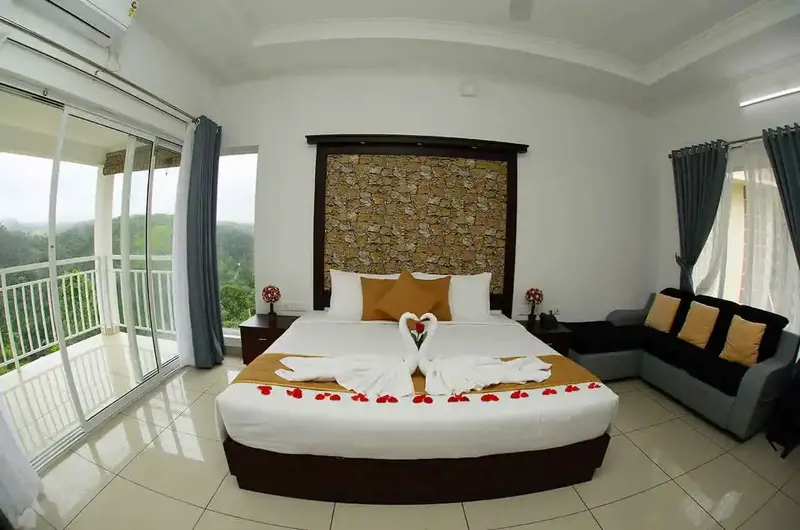 Honeymoon suite bedroom interior with romantic bed decorations and balcony doors at The Grasmere Resort Vagamon.