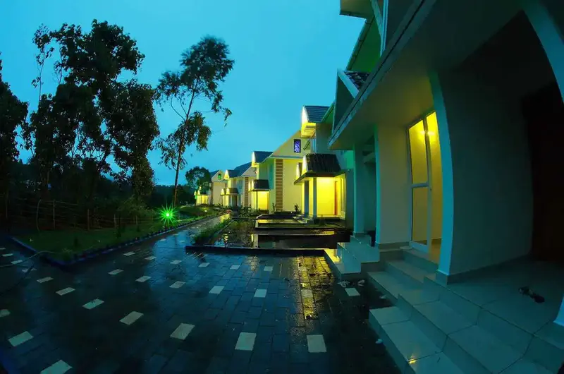 Cozy premium mountain cottages with warm night lighting in Vagamon.