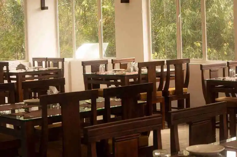 Spacious resort restaurant dining hall with wooden tables and chairs at The Grasmere Resort Vagamon.