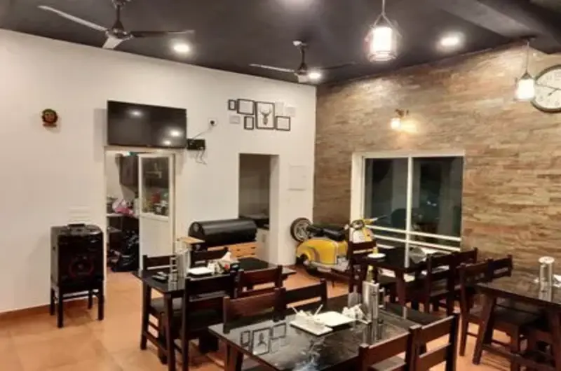 Indoor dining area and restaurant setup at Heaven Valley Resorts Vagamon with modern lighting and seating.