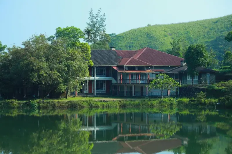 Waterfront cottage building overlooking a peaceful natural pond at Orion County Vagamon