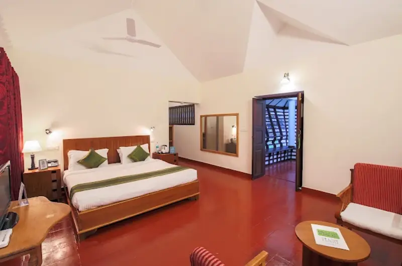 Spacious villa room interior featuring red tiled flooring, seating lounge, and wooden ceiling structure at Adrak Summer Sand Hill Resort