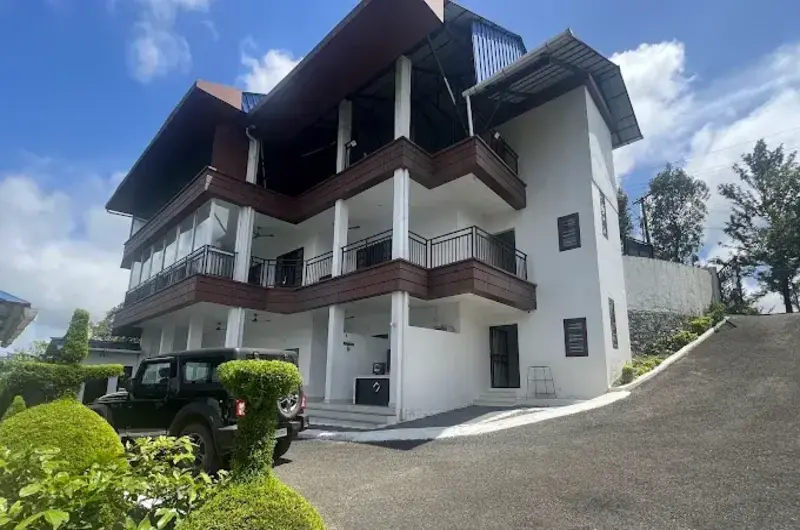 Exterior view of modern multi-story homestay building at Moon Palace Kuttikanam