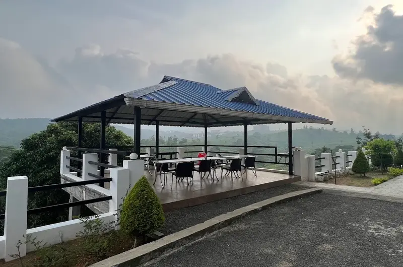 Open rooftop balcony viewpoint overlooking scenic hills and cloud-covered valleys