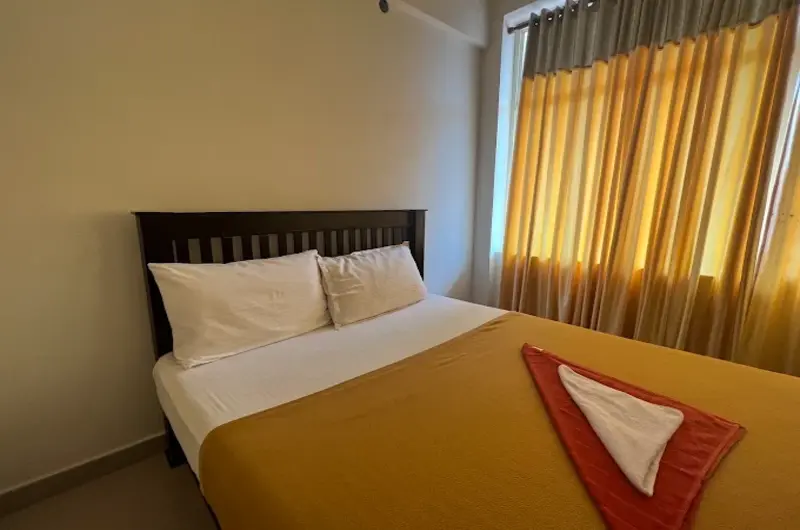 Cozy guest room bedroom featuring a comfortable double bed, warm lighting, and bedside tables