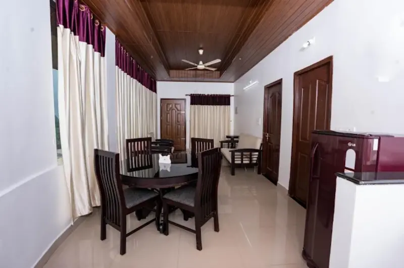 Spacious homestay living room suite with dark wood furniture, dining table, and modern ceiling lights