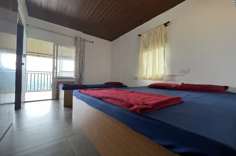 Deluxe resort bedroom featuring twin beds, warm lighting, and private balcony access