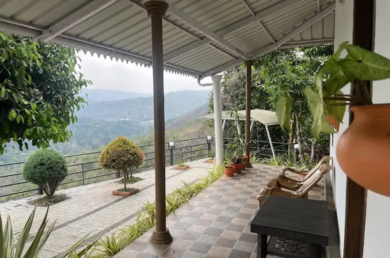 Shaded poolside seating area and deck with panoramic views of Vagamon hills
