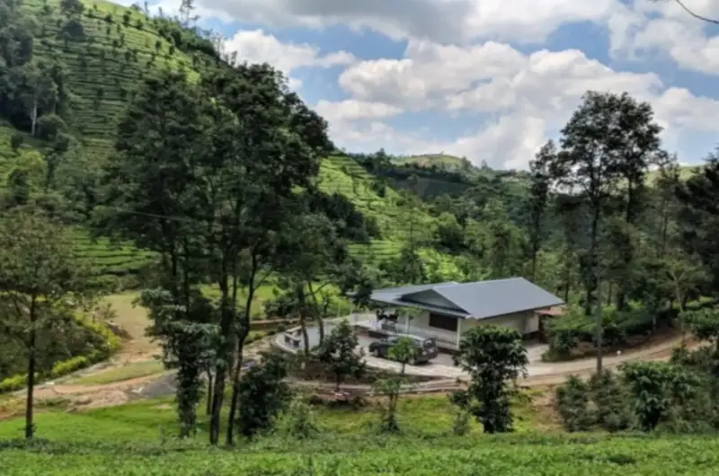 Overview of Vagamon Hues property set against lush green tea garden hills and valleys