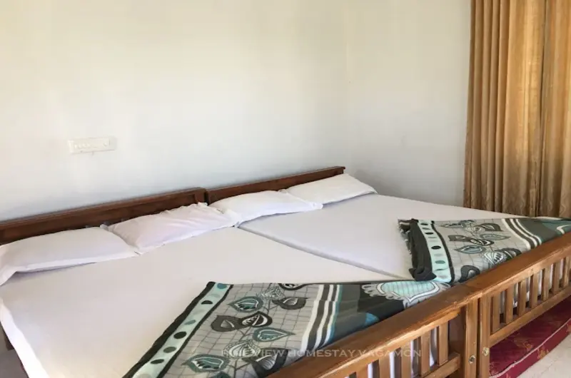 Spacious resort bedroom with double bed, warm ambient lighting, and bedside tables