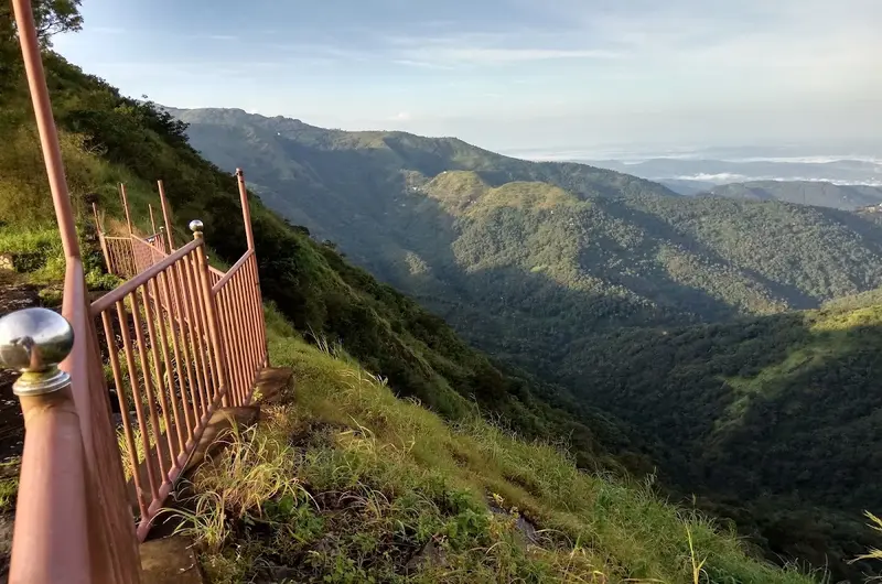 Scenic mountain valley view looking over a wooden fence deck toward misty green hills at Orion County Vagamon