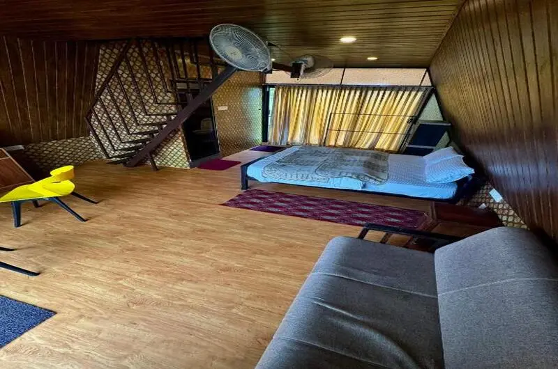 Rustic wood-paneled bedroom suite with plush bed and warm lighting at JMount Vagamon Resort