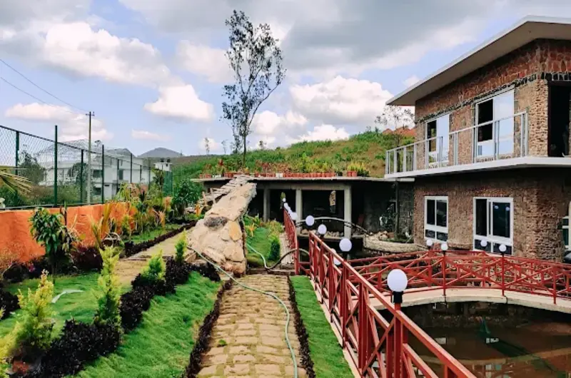 Paved stone pathway running alongside landscaped gardens and resort rooms at Vaga Copper Castle