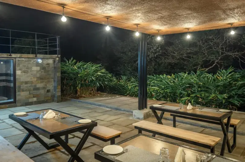 Paved outdoor patio deck with modern lounge seating illuminated at night
