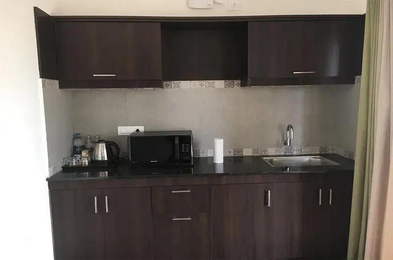 Modern dark wood kitchenette and vanity area inside guest cottage at Beyond Pines Vagamon