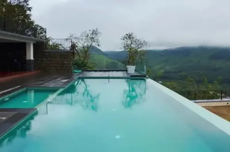 Infinity swimming pool overlooking foggy mountain valley and pine forests at Beyond Pines Vagamon