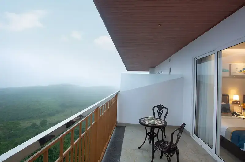 Private guest room balcony deck with seating overlooking scenic green hills at Le Crown Hotel Vagamon