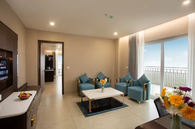 Luxury suite living room interior with plush sofa seating and balcony view at Le Crown Hotel Vagamon