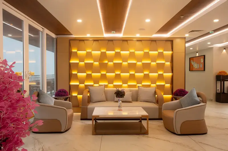 Spacious lobby seating area with plush sofas and decorative wall feature at Le Crown Hotel Vagamon