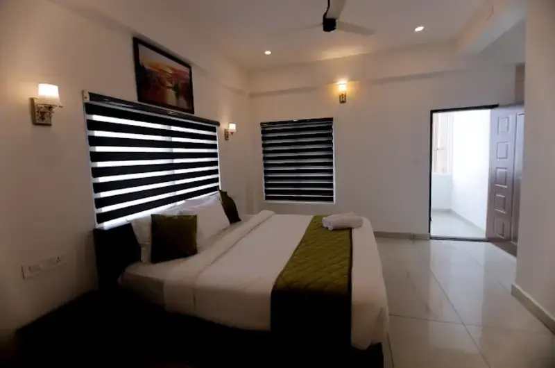 Modern guest bedroom interior with plush double bed at Himasailam Resort Vagamon