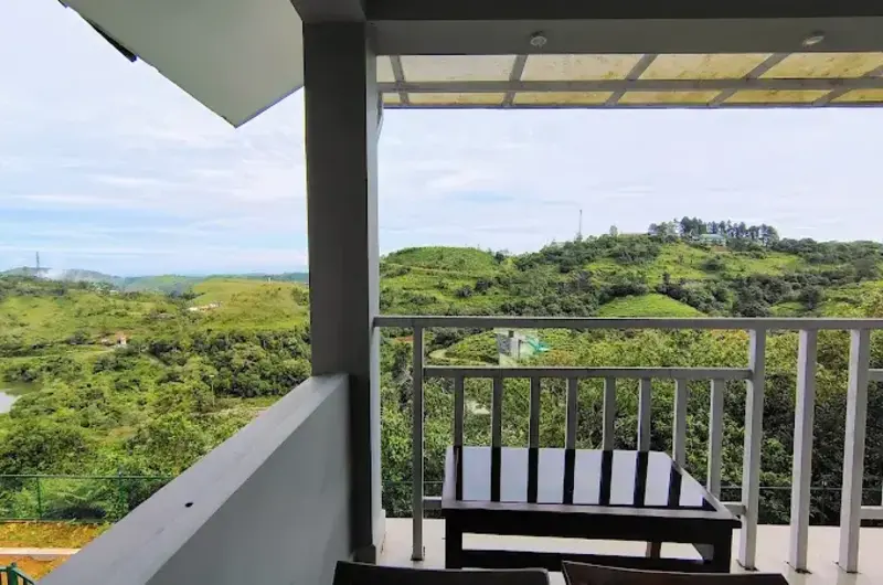 Covered resort balcony deck overlooking scenic green mountain valleys at The Autumn by Maat Hotels Vagamon