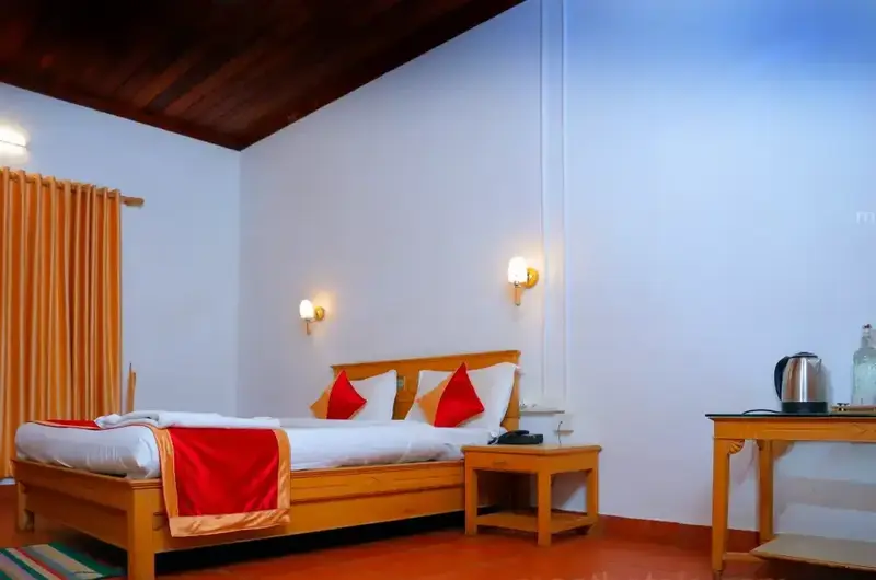 Cozy guest bedroom interior featuring comfortable beds and red accent linens at The Autumn by Maat Hotels Vagamon