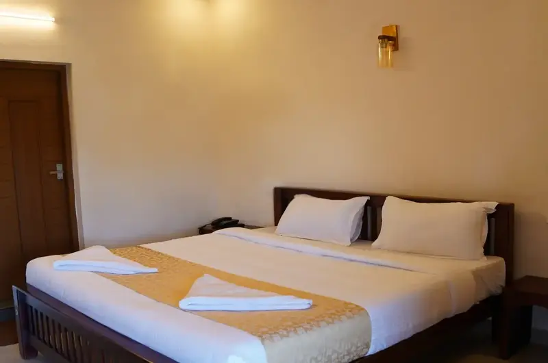 Elegantly furnished resort bedroom with warm ambient bedside lighting at The Autumn by Maat Hotels Vagamon