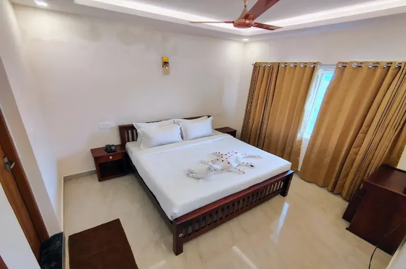 Spacious air-conditioned guest bedroom with modern amenities at The Autumn by Maat Hotels Vagamon