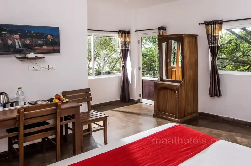 Resort room interior featuring private dining table and seating at The Autumn by Maat Hotels Vagamon