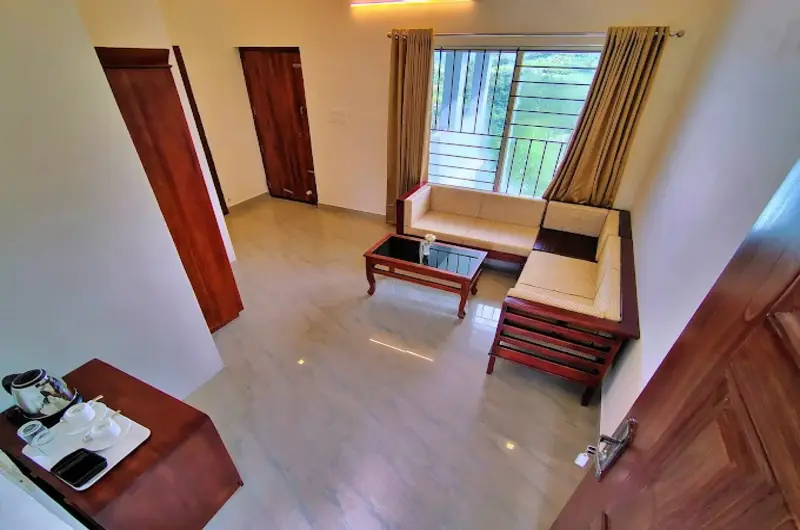 Spacious room interior with wooden desk workspace and large windows at The Autumn by Maat Hotels Vagamon