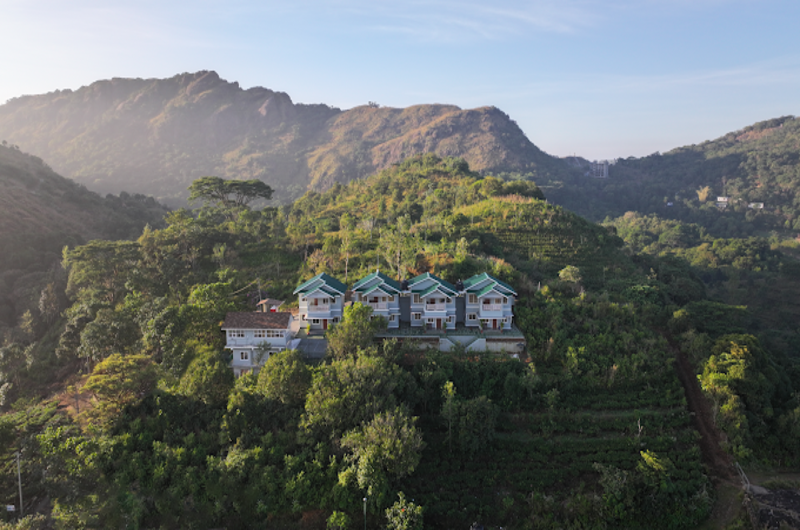 Panoramic view of foggy mountain ranges and pine covered hills near The Autumn by Maat Hotels Vagamon
