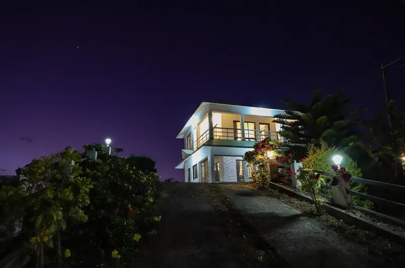 Illuminated exterior view of homestay building at night under starry sky at The Nest Homestay Vagamon