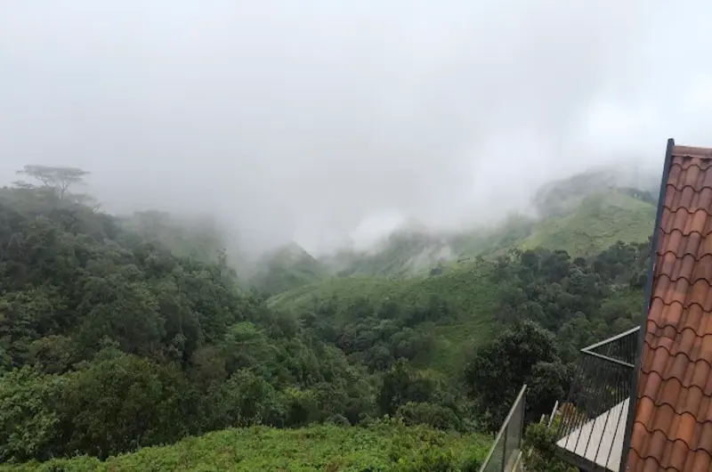 Panoramic misty mountain valley view from Trip Mount resort Vagamon