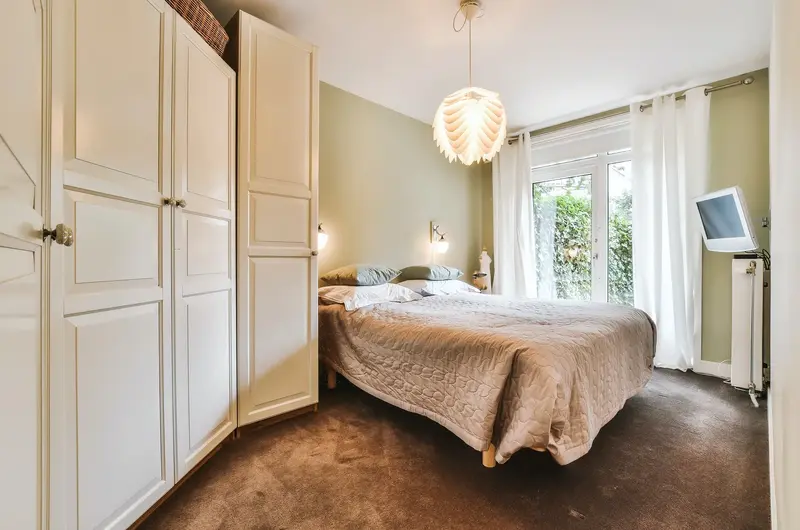 Cozy cottage bedroom interior with modern amenities and warm decor at Trip Mount Vagamon