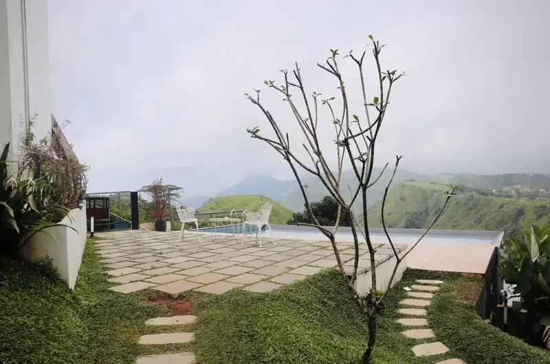 Paved garden path leading to guest cottages at Trip Mount resort Vagamon