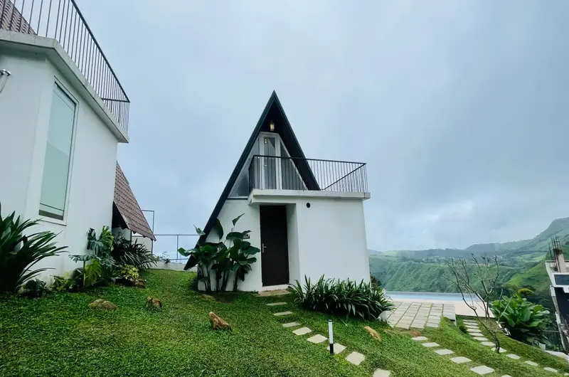 Scenic hill view and lawn area outside A-frame cottages at Trip Mount Vagamon