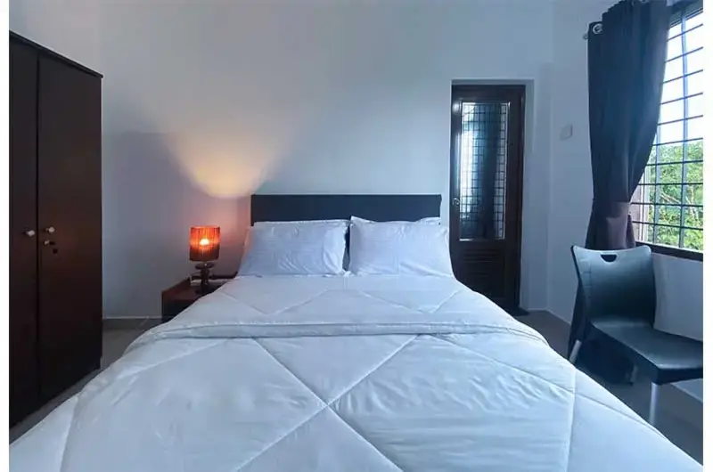 Cozy resort guest room with double bed and bedside lamp at Angel's Vagamon