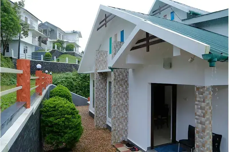 Paved garden path leading to guest room building at Angel's Vagamon