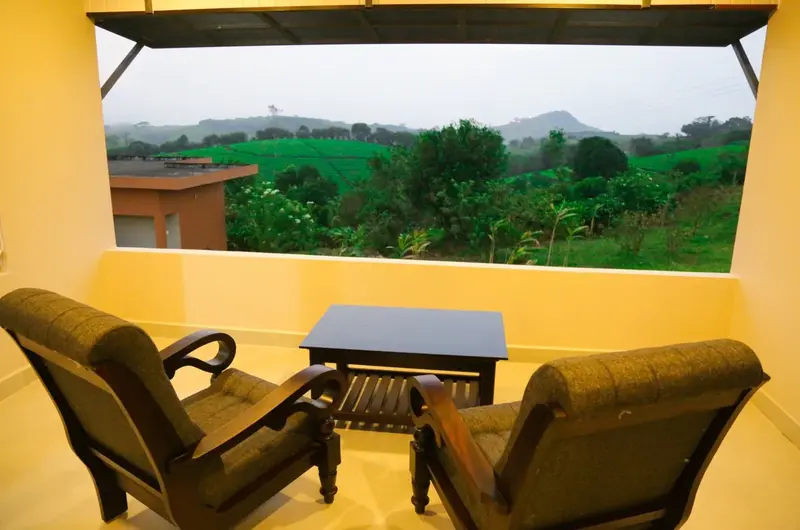 Cozy resort room interior with warm yellow walls and plush armchairs at Cee Cee Grand Resort Vagamon