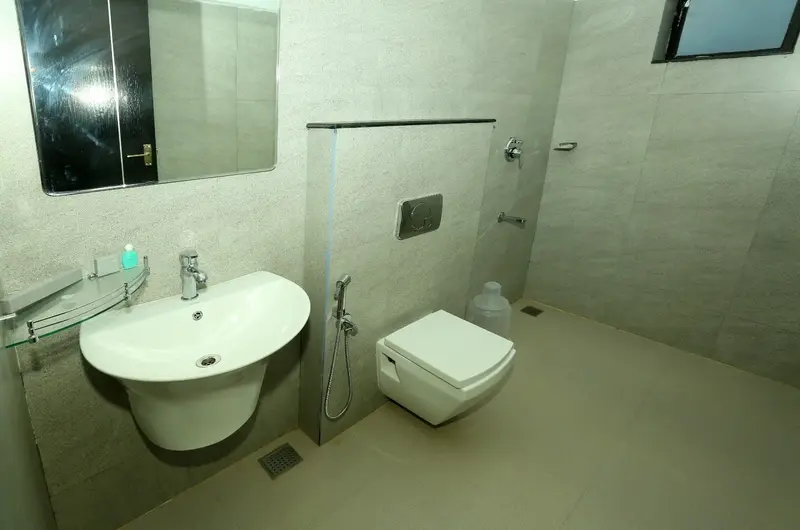 Clean modern attached bathroom with white sink vanity and premium fixtures at Cee Cee Grand Resort Vagamon