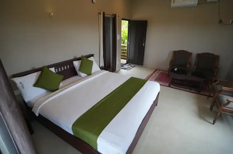 Modern resort guest room with king bed and private balcony access at Cee Cee Grand Resort Vagamon
